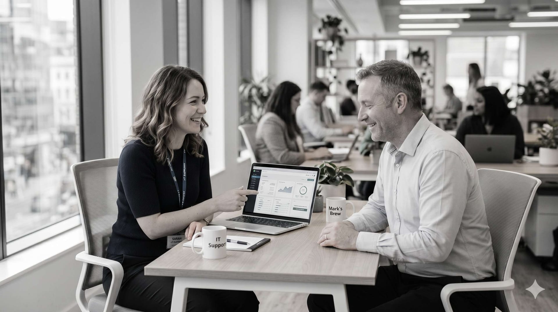 Adelaide-based IT support specialist working alongside a business owner — reviewing his technology environment together at a desk